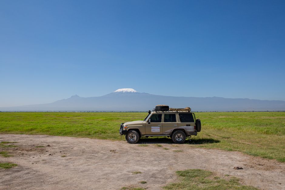 Rent a Car in Arusha Tanzania: What to Check Before You Book 3 4x4 vehicle on savannah with Mount Kilimanjaro in the background